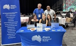 People around a table with banners