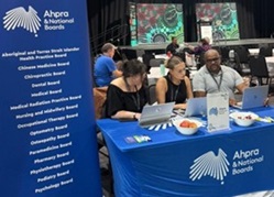 People around a table with banners